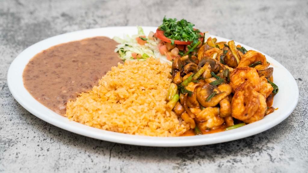 Devils Shrimp · Sautéed shrimp, distilled butter, white wine, garlic, mushrooms, onions, house special spicy sauce. Served with rice, beans and tortillas.