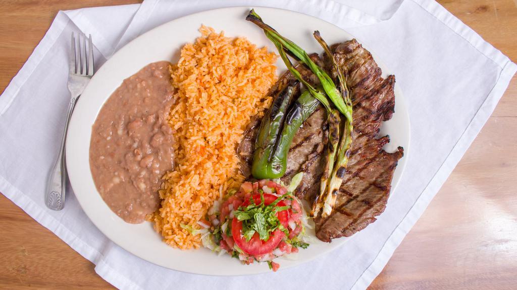 Carne Asada Plate · Flank steak, grilled green onion, served with rice, beans, and tortillas.