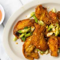 Canh Ga Chien Bo / Chicken Wings (8) · Battered & fried crispy salt & pepper chicken wings tossed with fried
garlic, green onion, a...