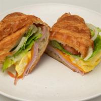 Croissant Breakfast · Scrambled Eggs, A Choice of Smoked Ham or Turkey Ham and Cheddar Cheese.
