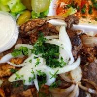 Mixed Shawarma Plate · Flame broiled chicken and beef, with rice, hummus, salad, tahini sauce and pita bread.