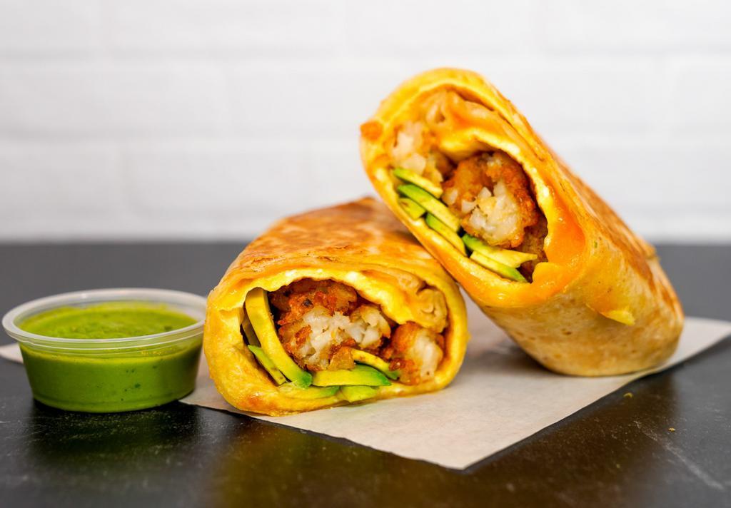 Avocado, Egg, & Cheddar Breakfast Burrito · 3 fresh cracked, cage-free scrambled eggs, melted Cheddar cheese, avocado salsa verde, fresh avocado, and crispy potato tots wrapped in a toasted 12” flour tortilla. Comes with avocado salsa verde side