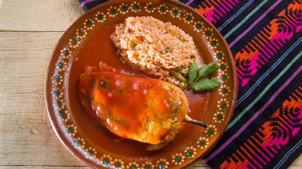 Cheese Chile Relleno · Green chile pepper, stuffed with cheese, lightly battered and fried and smothered in our homemade Ranchero sauce. Served with a side of rice and beans.