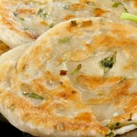 Gk Pan  · Housemade flaky bread with scallions. Tortillia size, yet thicker and flakier.