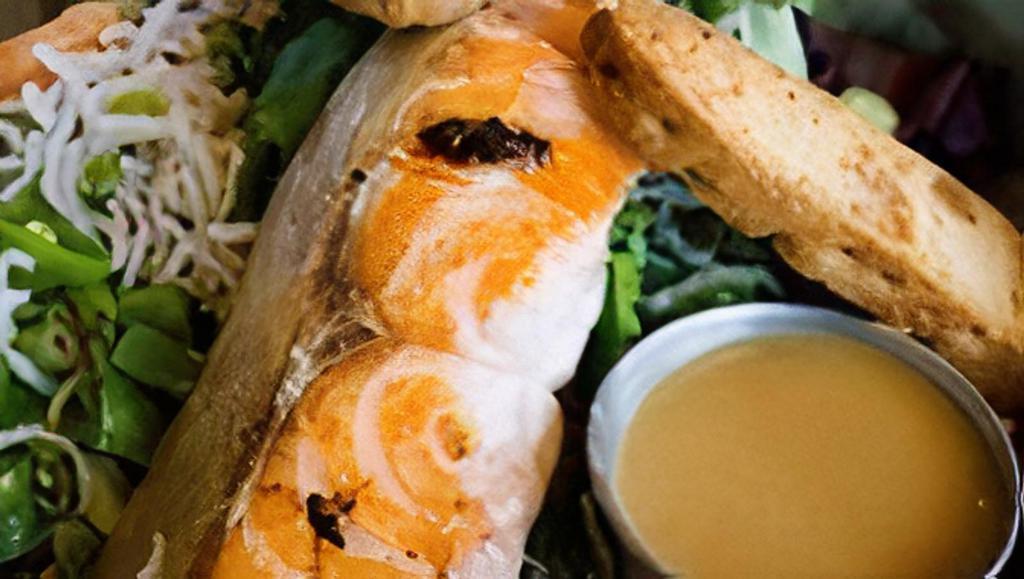 Asian Salmon Salad · Grilled Salmon on a bed of Organic Field Greens tossed in Ginger Miso Dressing with Toasted Sesame Seeds, Snap Peas, Cilantro, Green Onions, Mandarin Orange Slices, and topped with Glass Noodles