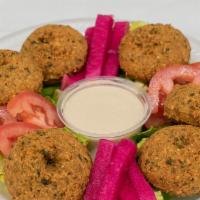 Falafel Balls · Ground chickpeas, fava beans, herbs & spices comes with tahini.