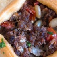 Sfiha (Meat Pie) · Homemade dough stuffed w/mixture of pine nuts, ground beef, onion, pomegranate molasses & sp...
