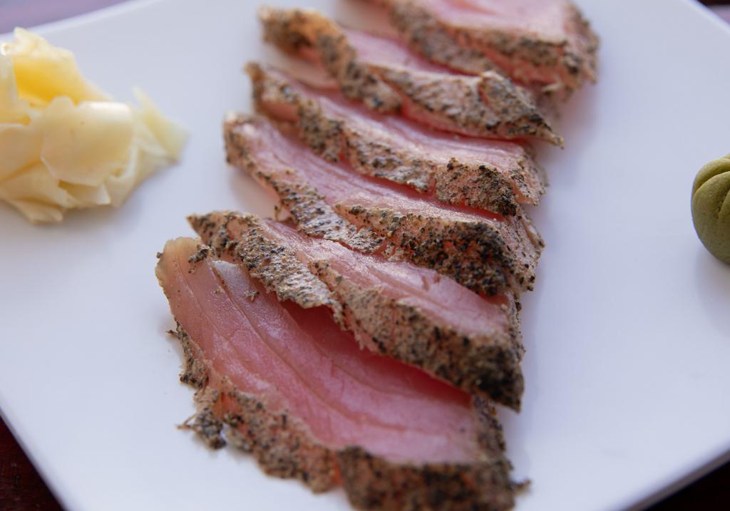 Seared Pepper Tuna Sashimi · Six pc ahi tuna with a seared pepper crust, drizzled in ponzu sauce.