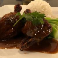 Duck Tamarind · Aromatic duck leg served with bok choy and tamarind sauce. Served with a scoop of steamed ja...