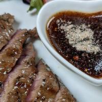 Crying Tiger · Thai spice grilled and sliced, served with spicy tamarind sauce. Served with a scoop of stea...
