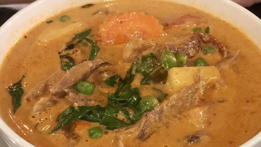 Roasted Duck Curry · Roasted duck cooked in red curry paste, coconut milk, tomato, pineapple, pea and Thai basil leave.