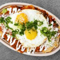 Chilaquiles · Our fresh Corn Tortilla Chips drowned in Hogao and the Salsa of your choice, Eggs, Garlic Cr...