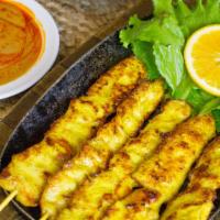 Satay · Marinated chicken skewers, pan-fried and served with cucumber salad and peanut sauce.