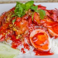 Bbq Pork Over Rice · Sliced BBQ pork served over white rice with a boiled egg and topped with a sweet sauce.