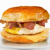 Classic Breakfast Sandwich · 2 fried Eggs with your choice of Ham, Bacon or Link Sausage with American Cheese on a toaste...