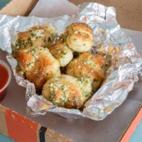 Garlic Knots · Tossed in olive oil, garlic and romano cheese.