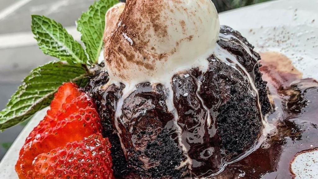 Molten Chocolate Cake · Dense chocolate cake with a molten truffle center, warm with vanilla bean ice cream.