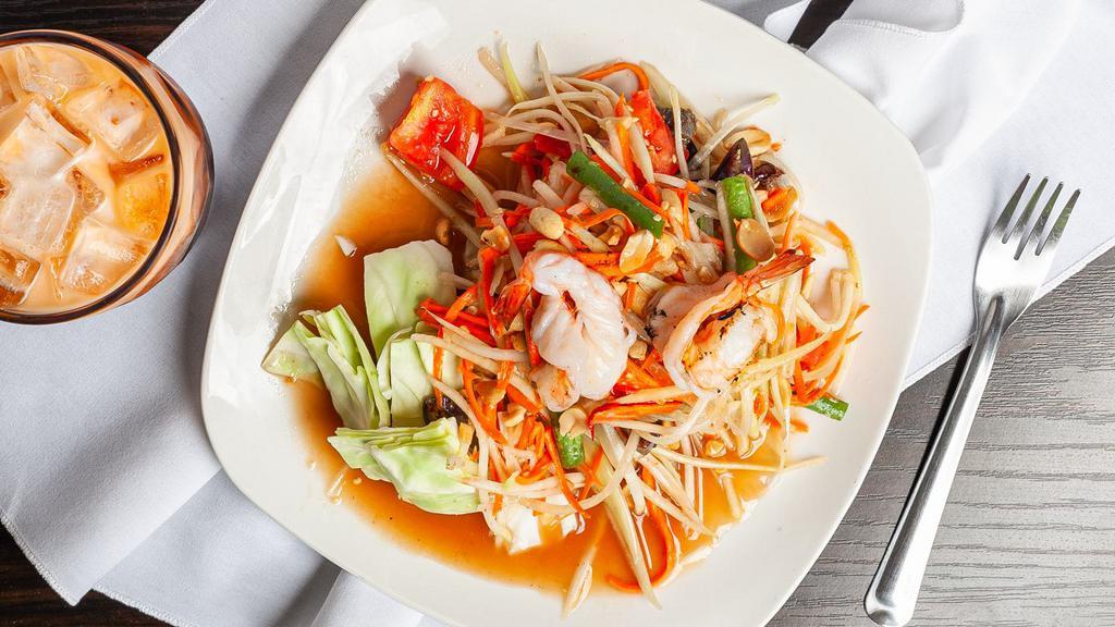 Som Tum Thai · Popular choice and spicy. Savory, sweet Papaya salad with tomato, carrot green beans, shrimp, and peanut.