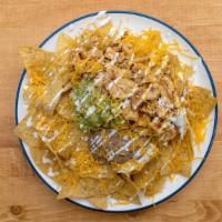 Classic Nachos · Refried beans, cheese, sour cream, and guacamole.