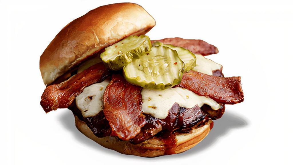 Devil'S Spit® Burger* · Slathered with Devil's Spit® BBQ sauce and topped with melted pepper-Jack cheese, bacon, lettuce, tomato and Hell-Fire Pickles.