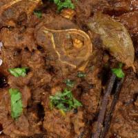 Punjabi Goat Curry · Goat with bone cooked in yogurt and medium spices.
