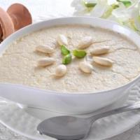 Elaichi Kheer · Creamy rice dessert,  delicately flavored with cardamom garnished with pistachio