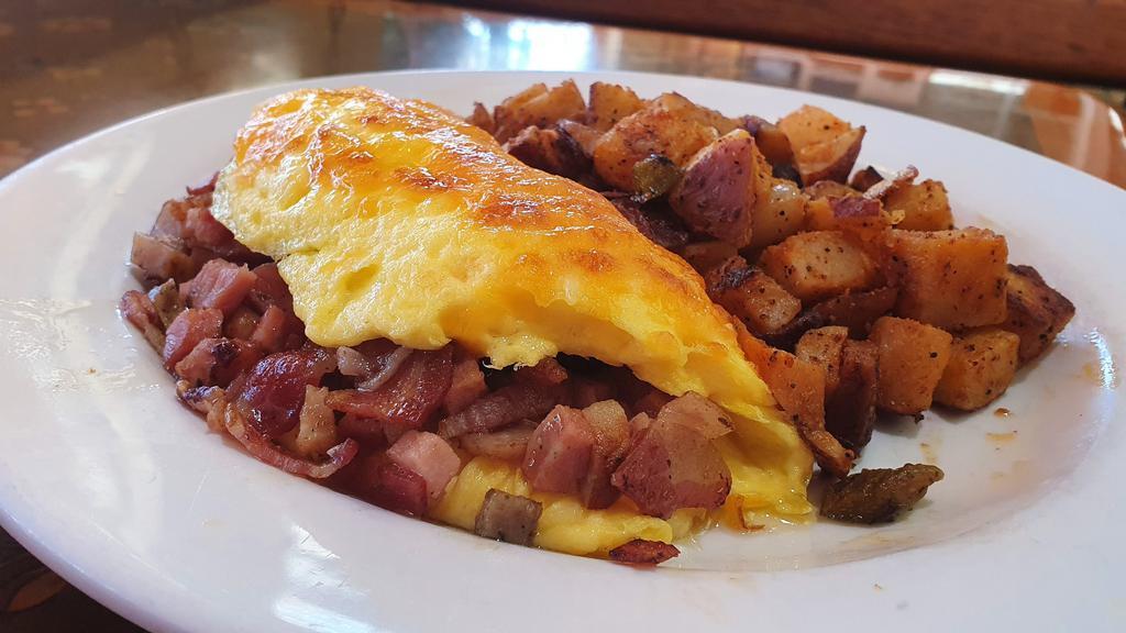 Hungry Hank · Four eggs, bacon, sausage, ham, andouille sausage, and cheese (a major meat-fest for your break-fast).