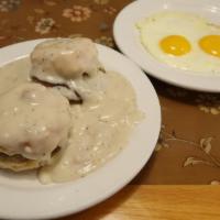 Mountain High Breakfast · Two sausage patties sandwiched in two fresh baked biscuits and smothered with our kountry gr...