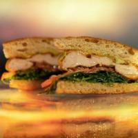 The Winger · grilled chicken with cheddar, nitrate free bacon, arugula, tomato, tarragon mayo, served on ...