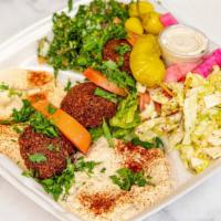 Vegetarian Combo Entrée · Vegetarian. Tabbouli, cabbage salad, hummus, Baba ghanoush, three pieces falafel, pita, and ...