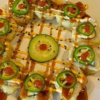 Ring Of Fire · In: salmon, imitation crab, cream cheese and avocado.
Top: eel sauce, spicy mayo, sriracha a...