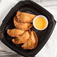 Empanadas · 1110 -1170 cal. Handmade pastries filled with mixed cheese and chicken tinga or seasoned gro...