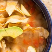 Chicken Tortilla Soup* · Homemade chicken broth loaded with chicken tinga, rice, zucchini and Jack cheese, topped wit...