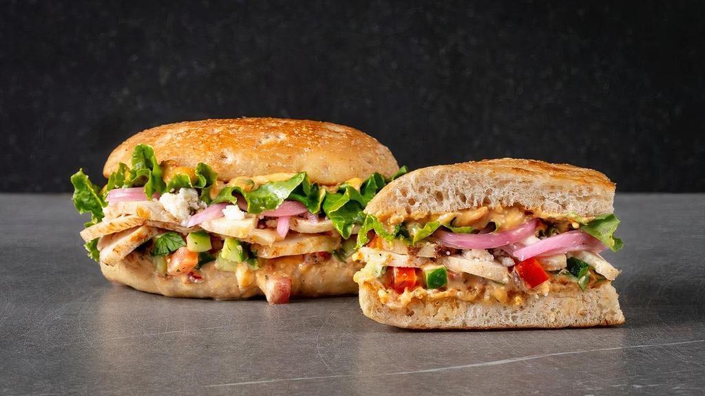 Mediterranean Chicken · roasted chicken, garlic red pepper hummus, green leaf lettuce, tomato cucumber salsa, pickled red onions, feta cheese.  Served with Urbane Side Salad