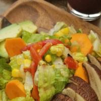 Grilled Portobello Salad · Romaine lettuce, grilled scallions, corn, carrots, and avocado with our house Tuscany dressi...