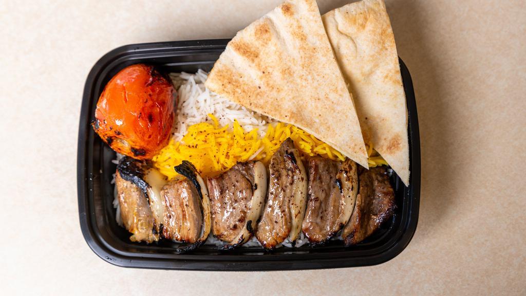 Lamb Shish Kabob · Tender, grilled pieces of lamb, marinated in our signature saffron seasoning, served with rice,  and hummus.