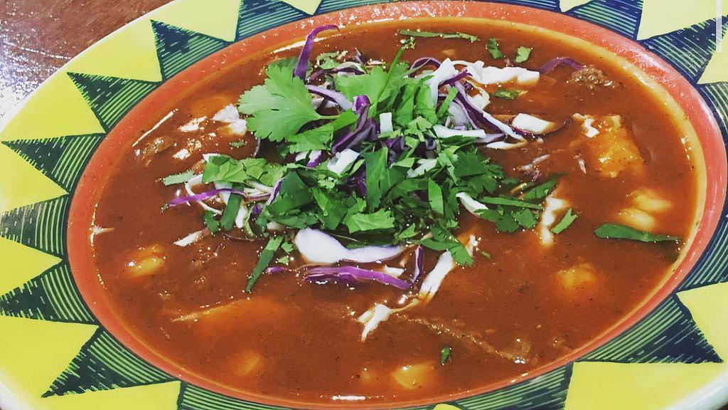 Pozole · Traditional hominy stew, chile broth with vegan chicken and beef, served with corn tostadas, lettuce, onion and cilantro.