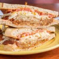 Reuben Sandwich · Vegan. Marinated tempeh, thousand island dressing, onions, tomatoes, melted Daiya cheese & s...