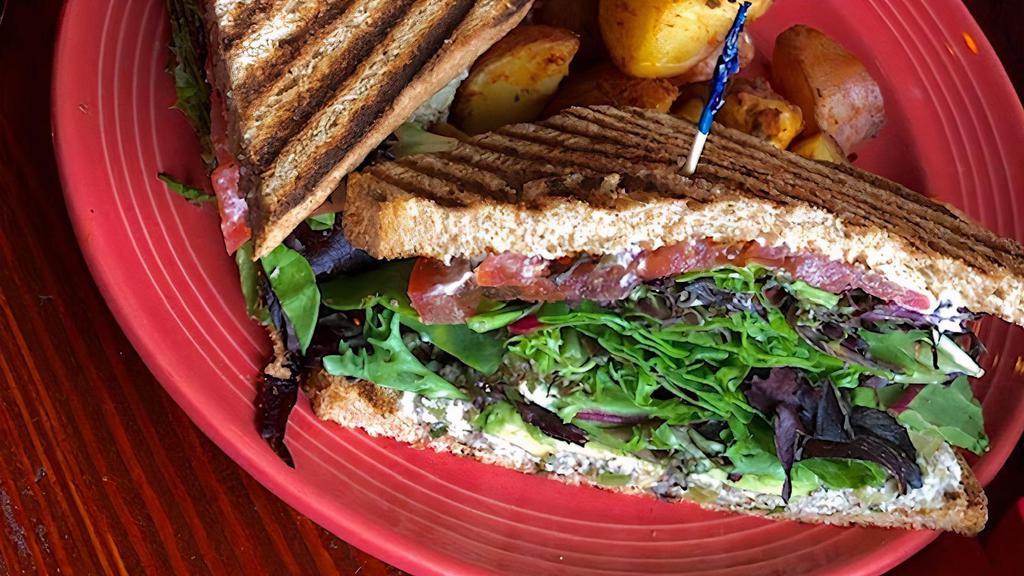 Tuna Melt Sandwich · Vegan. Served on toasted wheat bread, Daiya cheese, pickles, lettuce, tomatoes, & avocado.