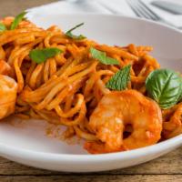 Shrimp Fra Diavolo · Poached shrimp (3 pcs), calabrian chili, pomodoro sauce, mint + basil, linguine pasta.