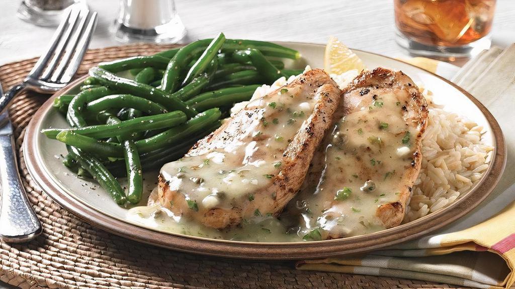 Lemon Chicken · Two tender seasoned and grilled chicken breasts  lightly coated with a lemon and caper sauce. Served with choice of two dinner sides.