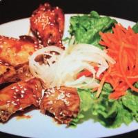 Sesame Chicken Wings · Chicken Wings tossed In a sweet and mildly spicy sauce topped with sesame seeds.
