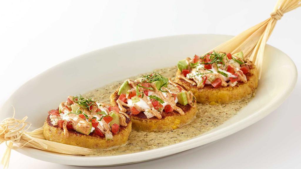 Sweet Corn Tamale Cakes · Topped with Sour Cream, Salsa, Cilantro, Avocado and Salsa Verde