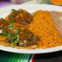 Taco Plate · 3 tacos with 1 choice of meat topped with onion and cilantro mix and salsa with a side of ri...