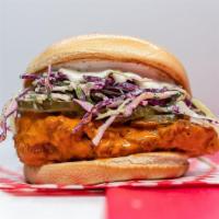 Buffalo Chicken Sandwich · country fried chicken breast tossed in buffalo sauce, slaw, lemon-herb mayo, pickles, brioch...