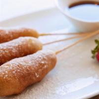 Breakfast Dogs · Three sausage links dipped in pancake battered fried to a golden brown.  Dusted with powdere...