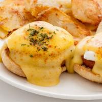 Classic Egg Benedict · Two poached eggs, Canadian bacon, and hollandaise sauce on an English muffin.