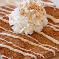 Churro French Toast · French Toast with cinnamon and sugar, topped with cream cheese icing and whipped cream.