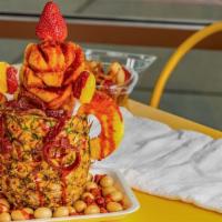Pina Loca · Crazy pineapple with oranges, crazy cucumber, strawberries topped with chamoy, Valentina, ta...