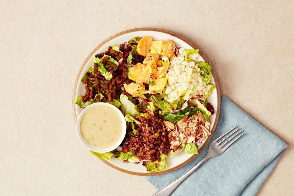 Chopped Salad · Our favorite chopped salad:  gem lettuce mix, falafel crispies, Hook's aged 2-year white cheddar, roasted and marinated yellow beets, chopped dates, toasted almonds and a side of GCC maple mustard vinaigrette. Gluten-free and vegetarian
